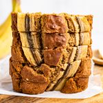 Slices of gluten-free and dairy-free banana bread stacked on top of each other.