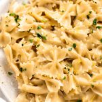Close up image of lemon pasta with parsley on top.