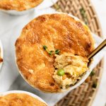 Overhead shot of three mini paleo chicken pot pies with a scoop taken out.