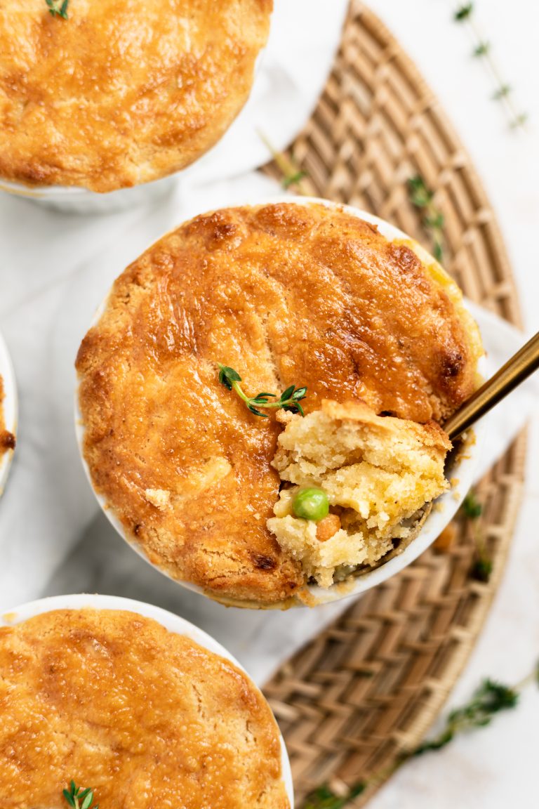 Overhead shot of three mini paleo chicken pot pies with a scoop taken out.