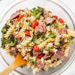 gluten-free pasta salad in a big bowl with a wooden spoon