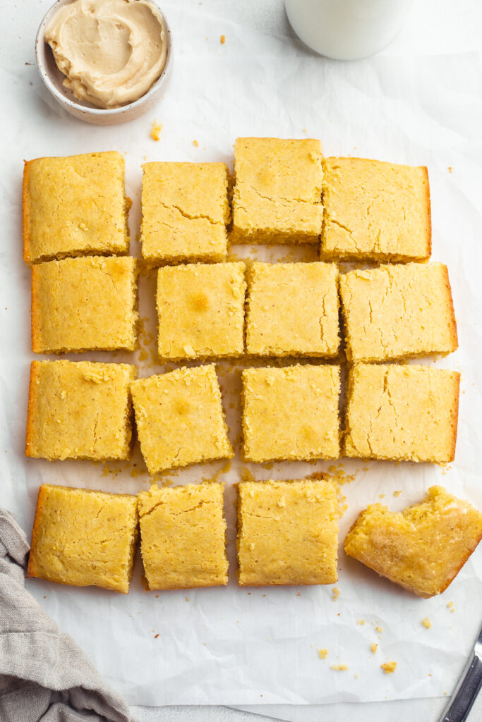 overhead image of gluten-free cornbread with honey butter on the side.