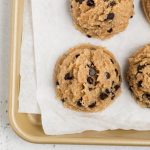 scoops of healthy cookie dough on a baking sheet