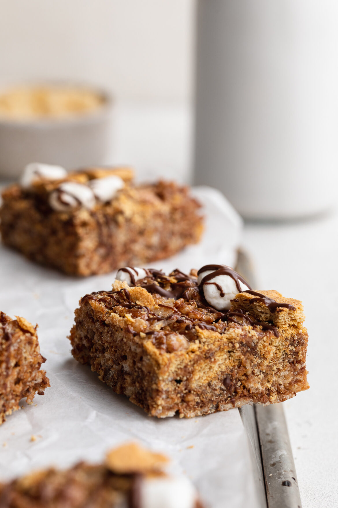 S’mores Rice Crispy Treats close-up image of a s'mores rice crispy treat on a baking sheet.