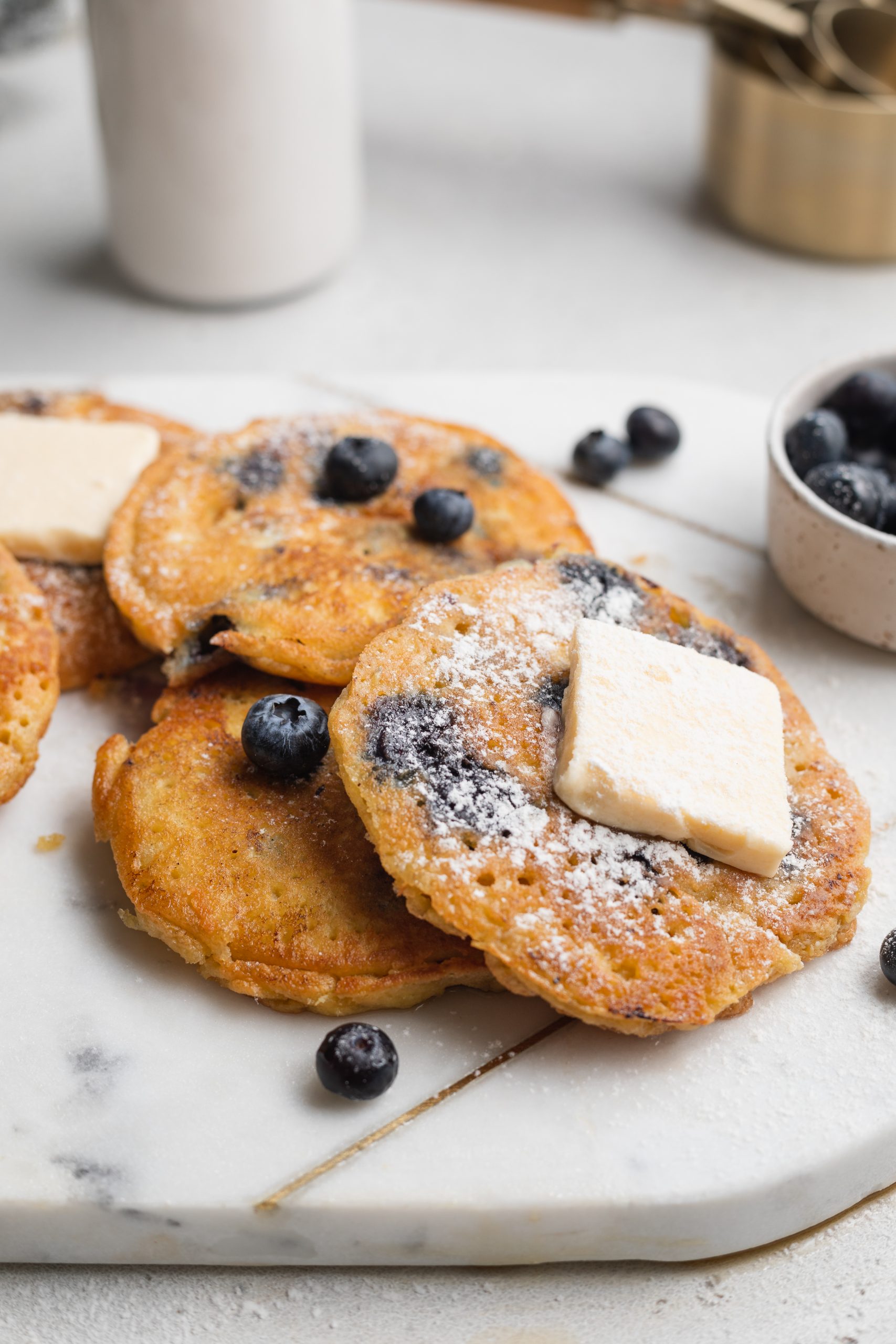 almond flour pancakes with blueberries on a marble board