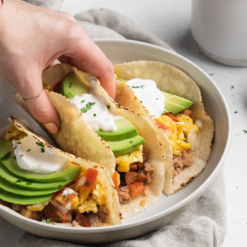 breakfast tacos being listed off of a plate