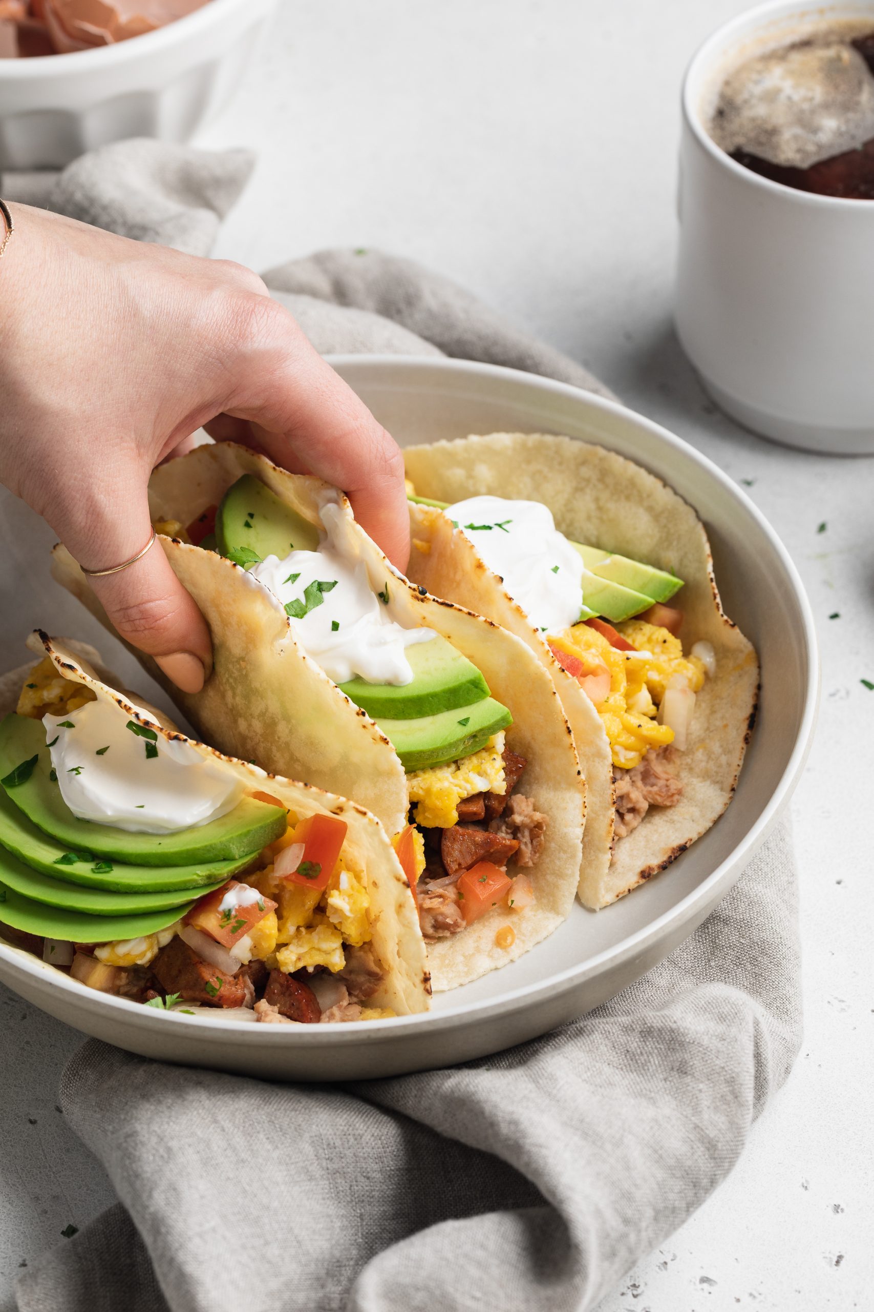 breakfast tacos being listed off of a plate