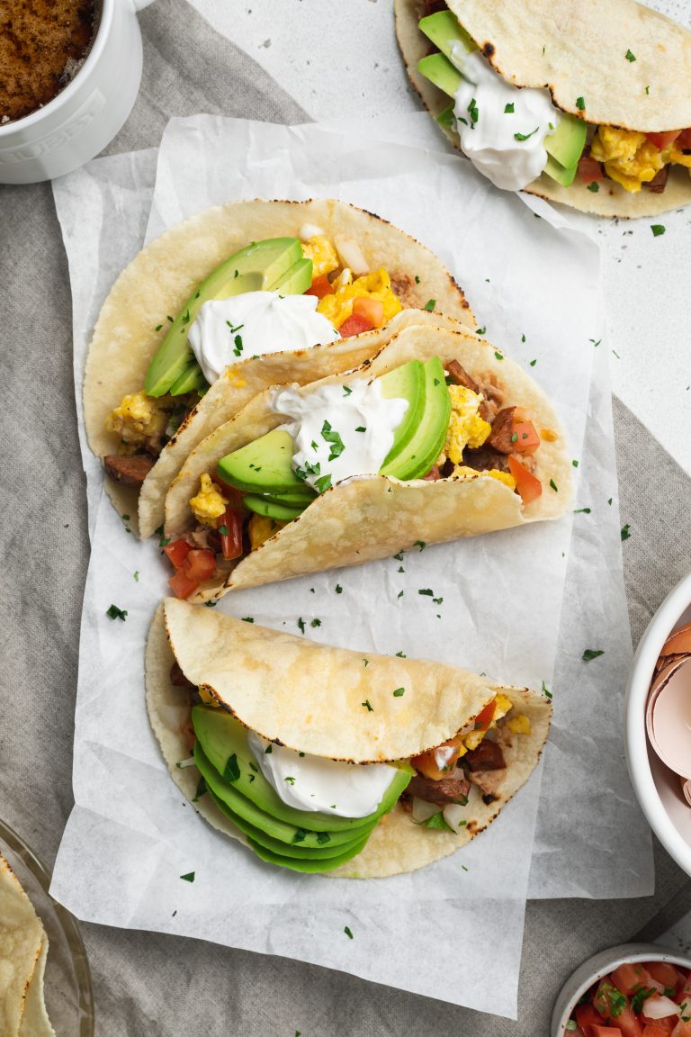 breakfast tacos with sliced avocado and vegan sour cream on top, and coffee on the side