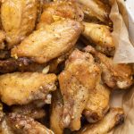 close-up overhead image of lemon pepper chicken wings on a plate