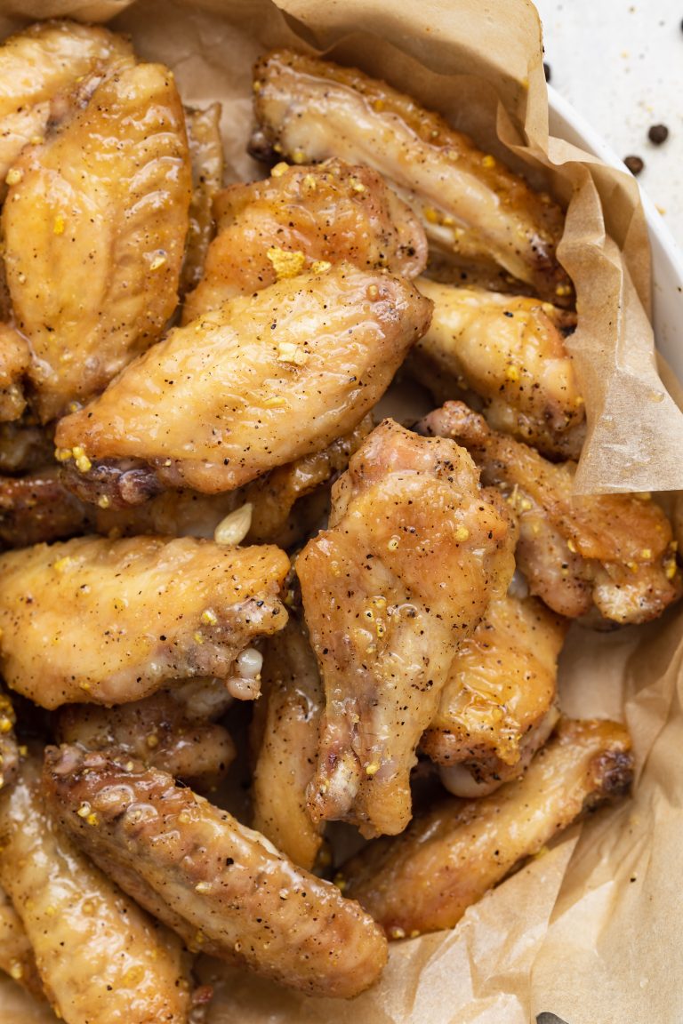 close-up overhead image of lemon pepper chicken wings on a plate