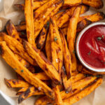 air fryer sweet potato fries on a plate with ketchup