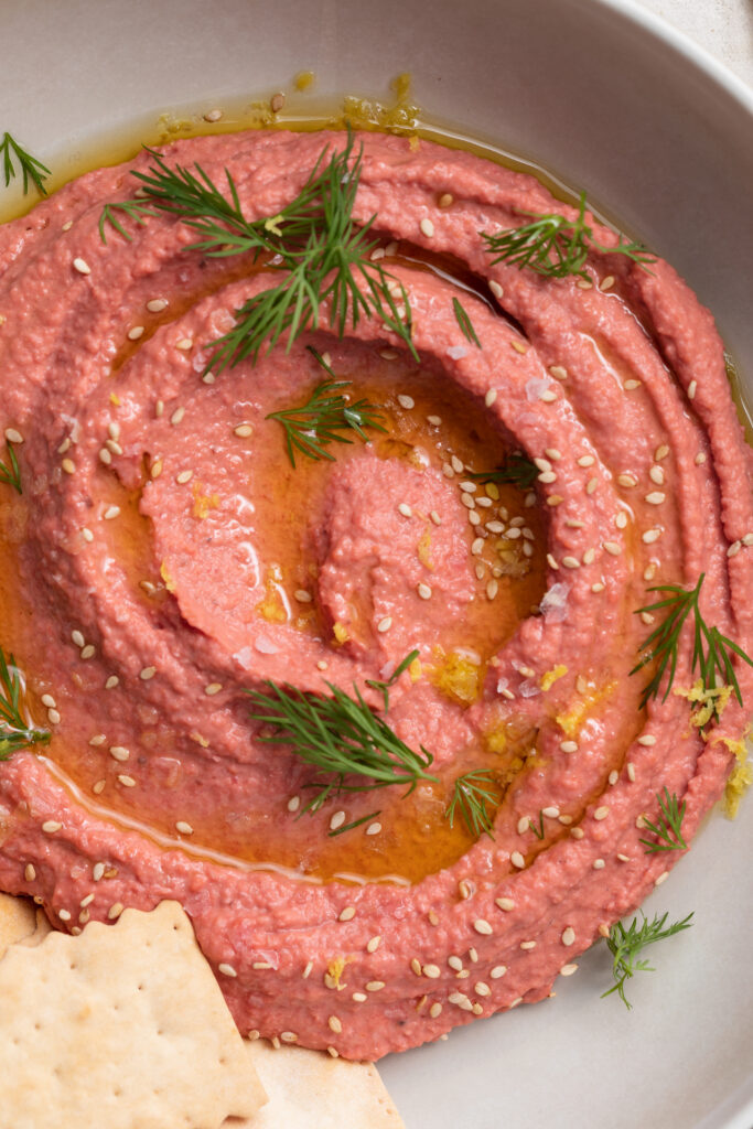 close-up image of beet hummus in a bowl.