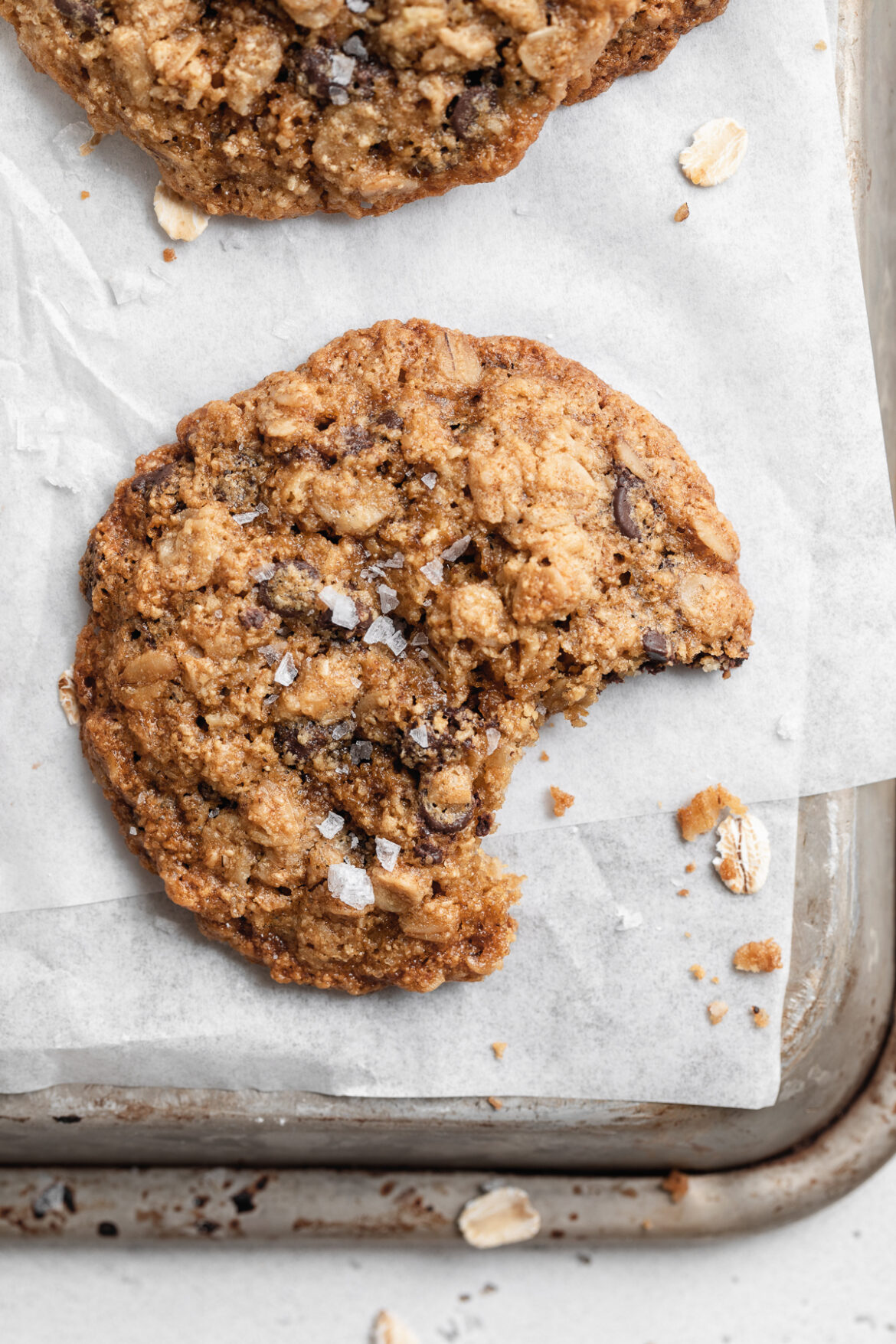 Gluten-Free Oatmeal Chocolate Chip Cookies gluten-free oatmeal chocolate chip cookies with a bite taken out.