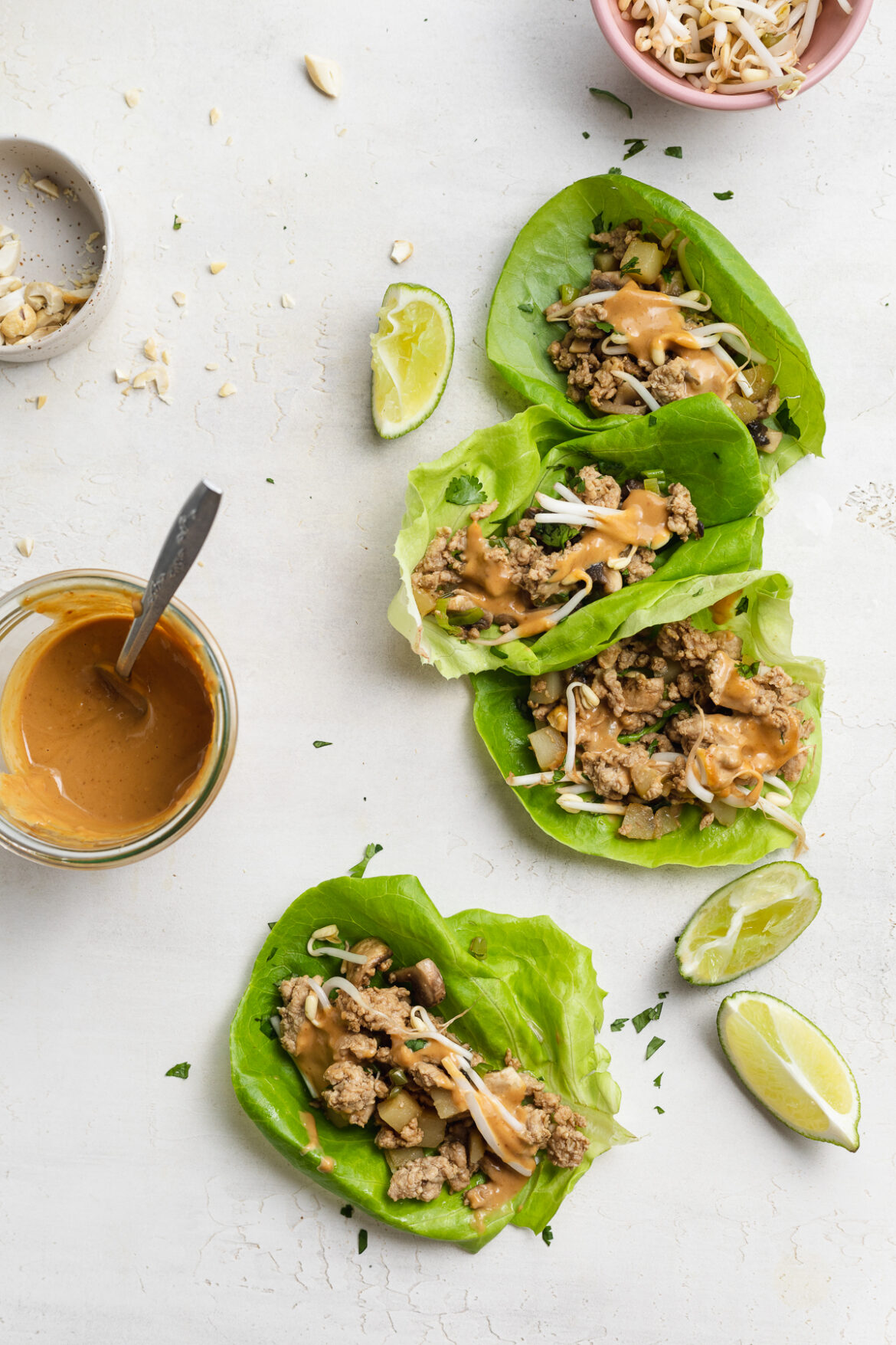 Asian Turkey Lettuce Wraps with Savory Peanut Sauce overhead image of asian turkey lettuce wraps on a table.