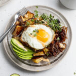 breakfast bowl with coffee and avocado on the side.