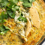 close-up image of vegan spinach artichoke dip with chips