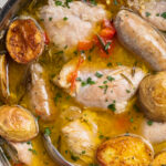 close-up image of chicken scarpariello in a skillet.