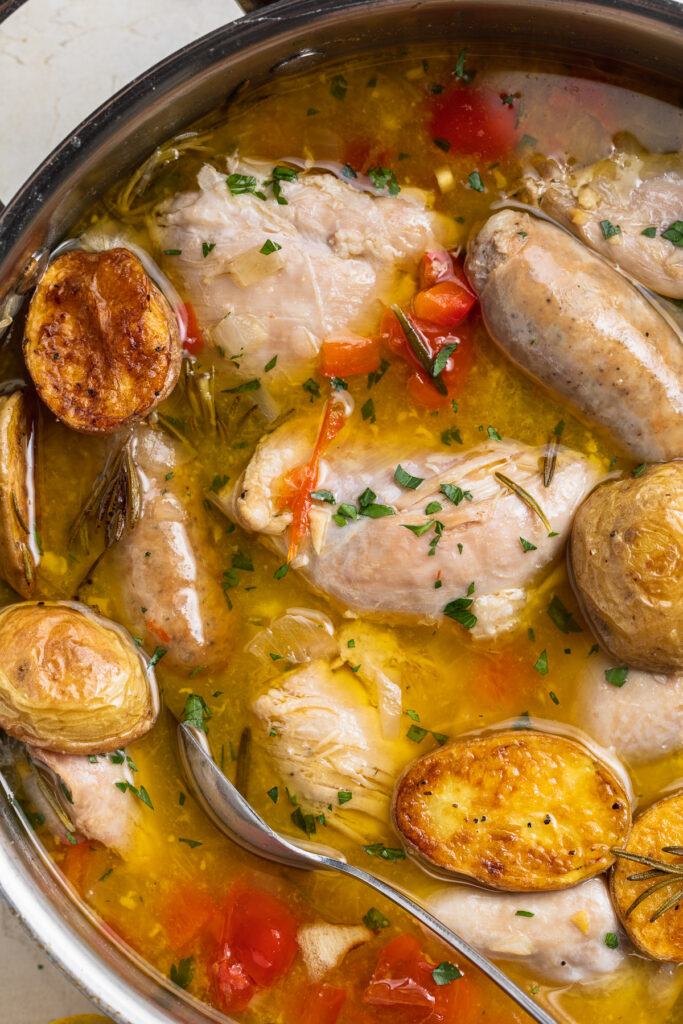 close-up image of chicken scarpariello in a skillet.