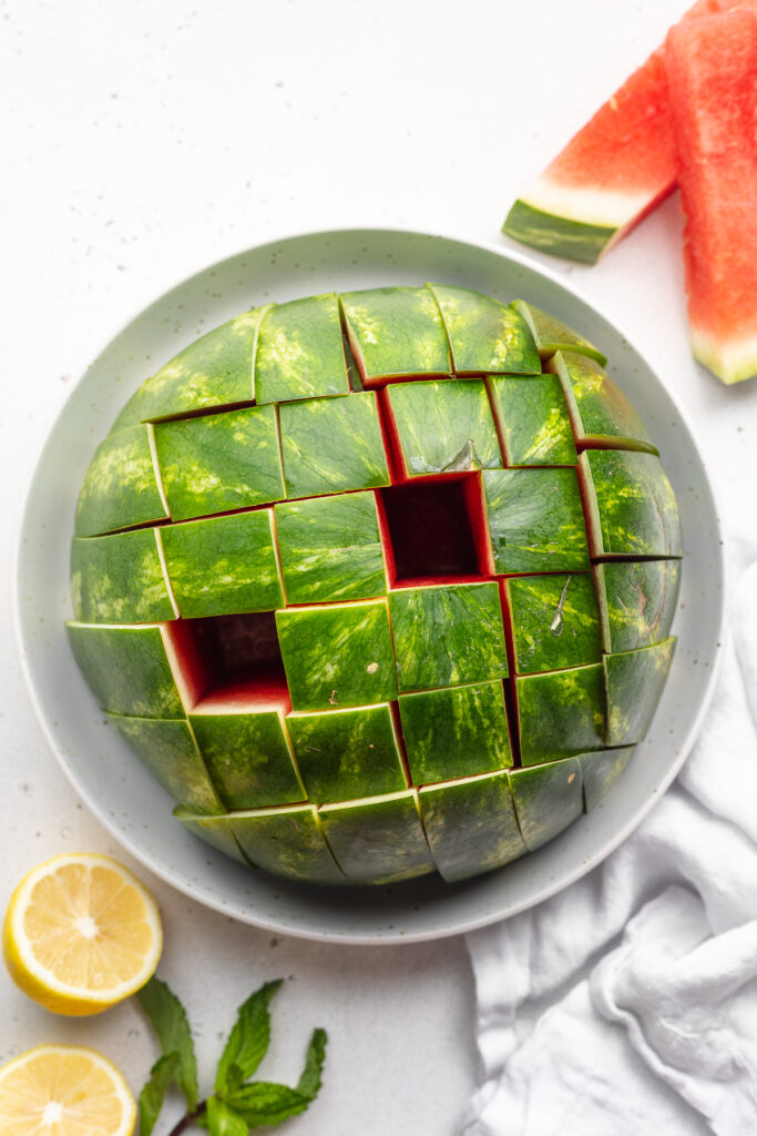 Watermelon cut into stick with lemon on the side.