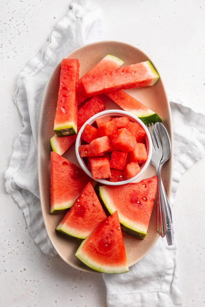 Watermelon cut three different ways on a serving platter.