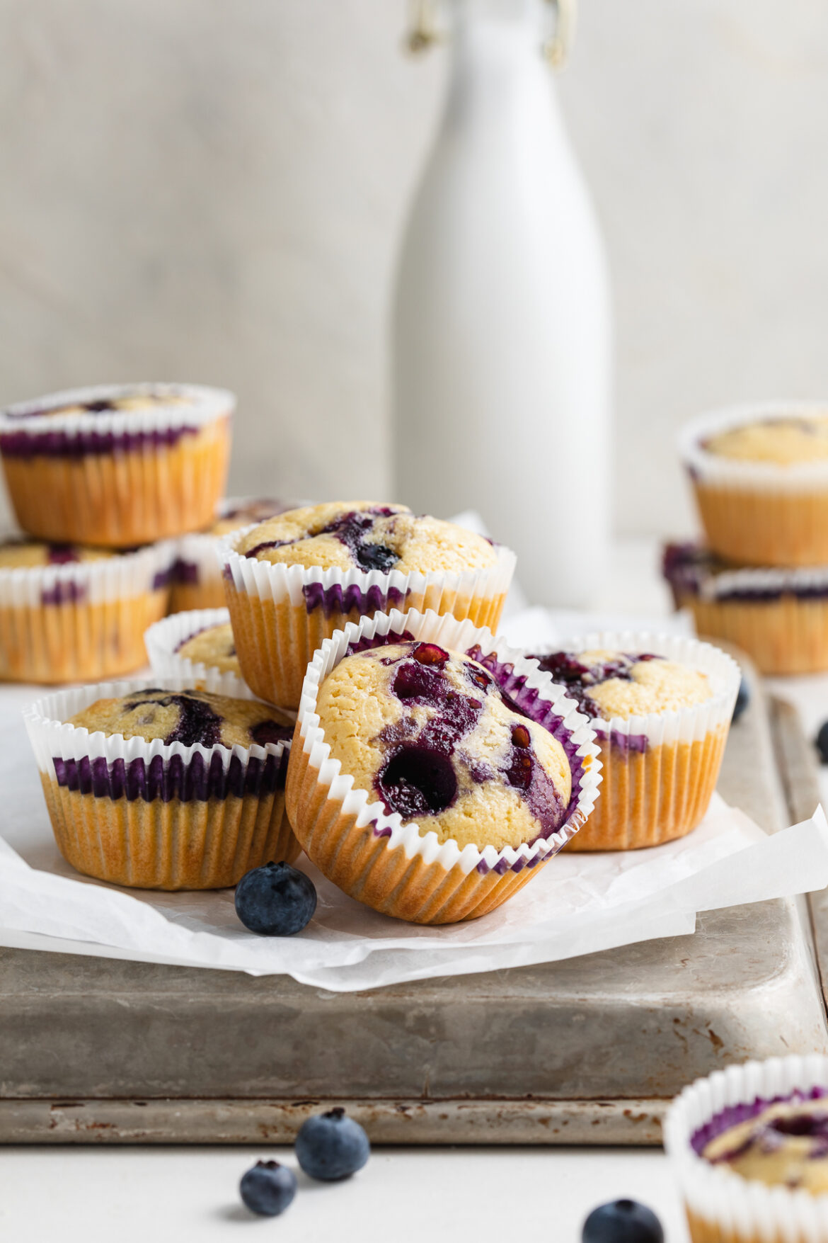 Gluten-Free Blueberry Muffins (Dairy-Free, Grain-Free) gluten-free blueberry muffins on a baking tray.