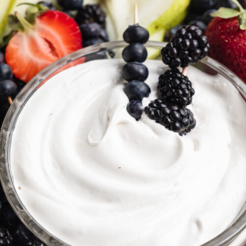 close-up image of marshmallow fruit dip with fresh berries.
