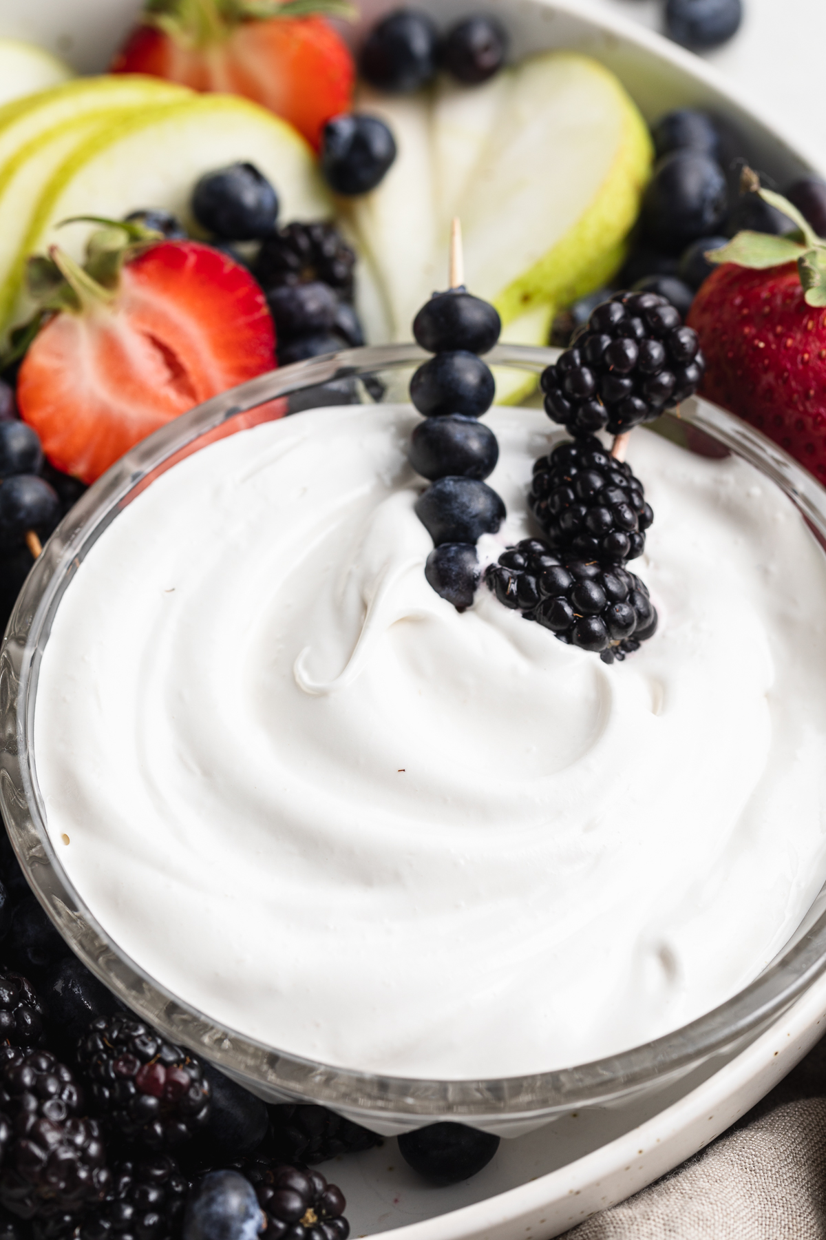 close-up image of marshmallow fruit dip with fresh berries.