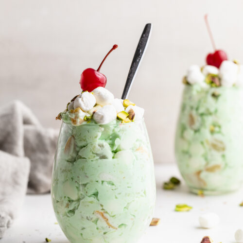 two glasses of watergate salad with cherries on top