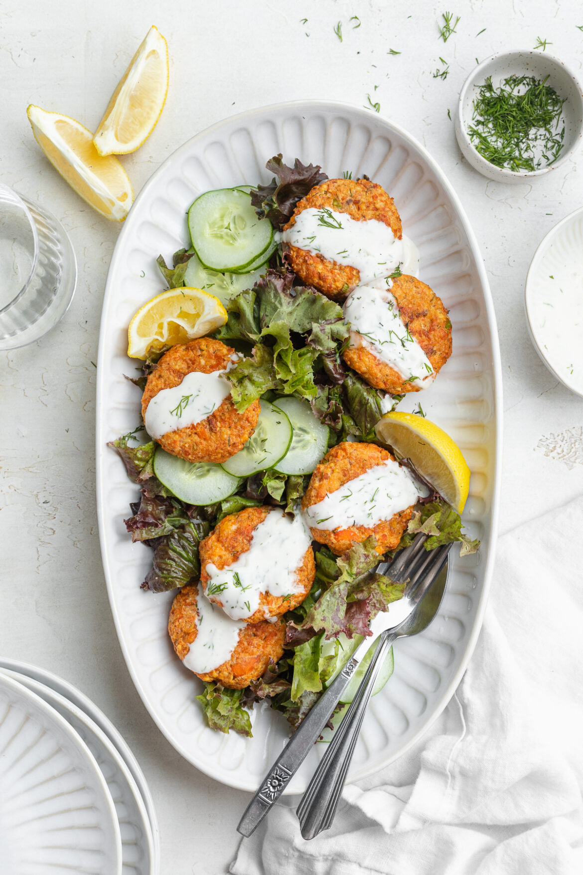 Air Fryer Salmon Patties with Creamy Dill Sauce overhead image of air fryer salmon patties on a platter.