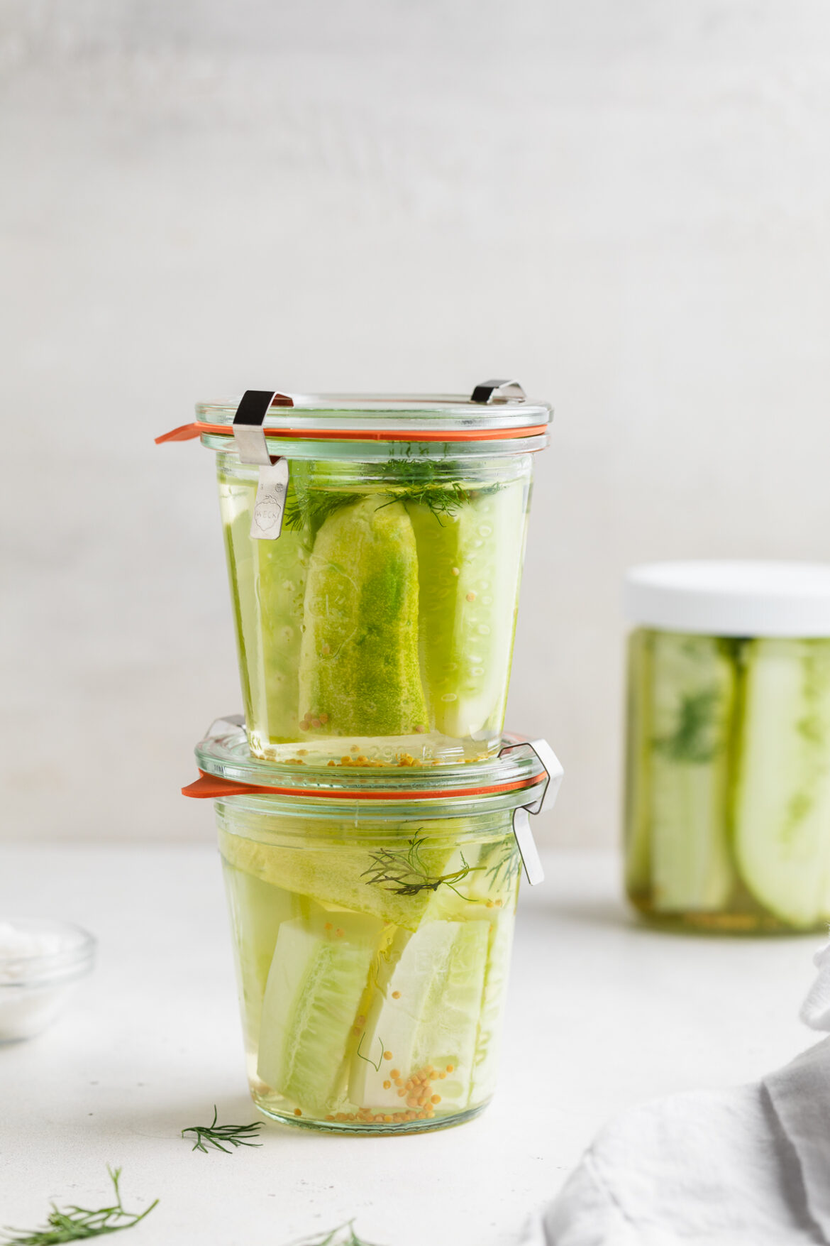 How to Make Pickles two jars of pickles stacked on top of each other.