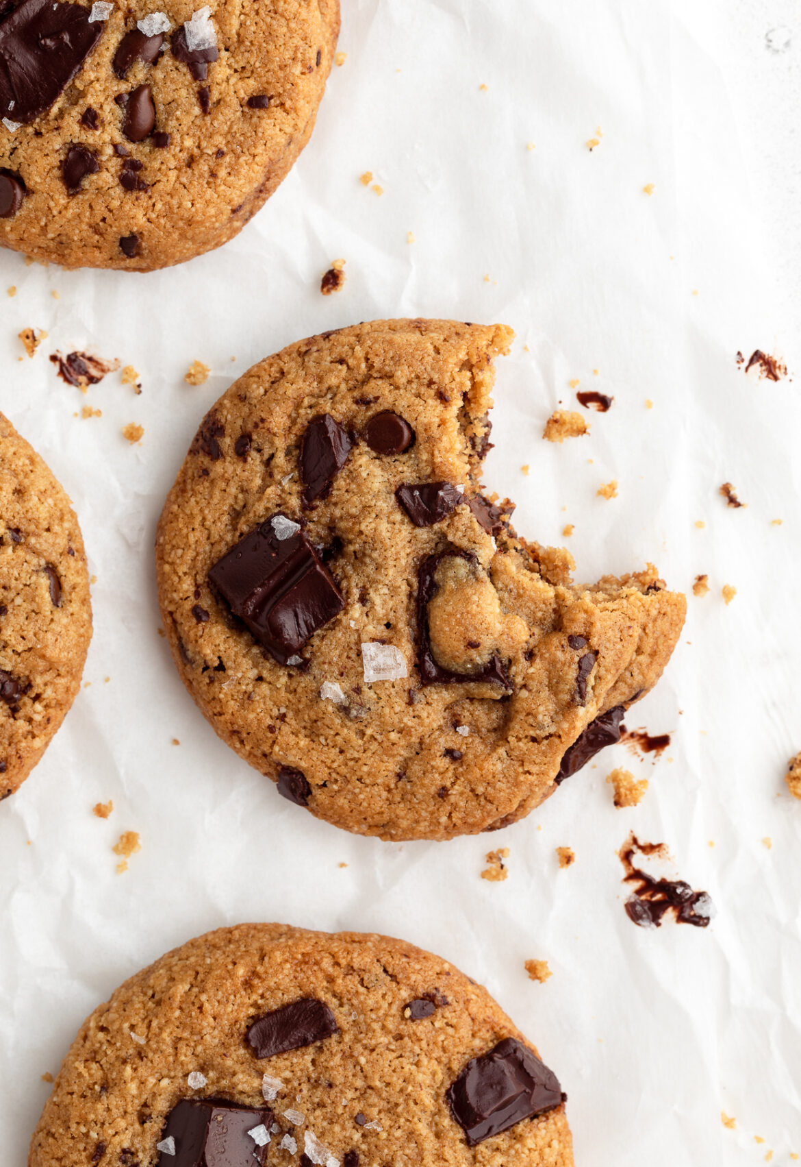 Perfect Almond Flour Chocolate Chip Cookies overhead image of an almond flour chocolate chip cookie with a bite taken out.