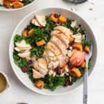 overhead image of a meal prep harvest bowl with sliced almonds on the side.