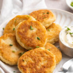 close-up image of mashed potato cakes on a plate.