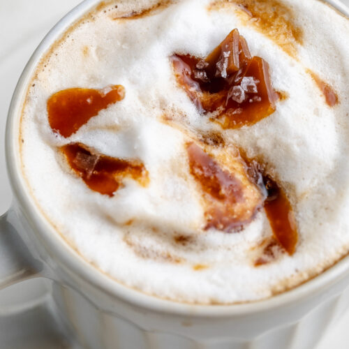 close-up image of a caramel brulée latte with extra caramel on top