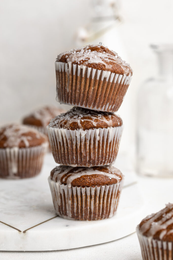 three gluten-free gingerbread muffins stacked on top of each other.