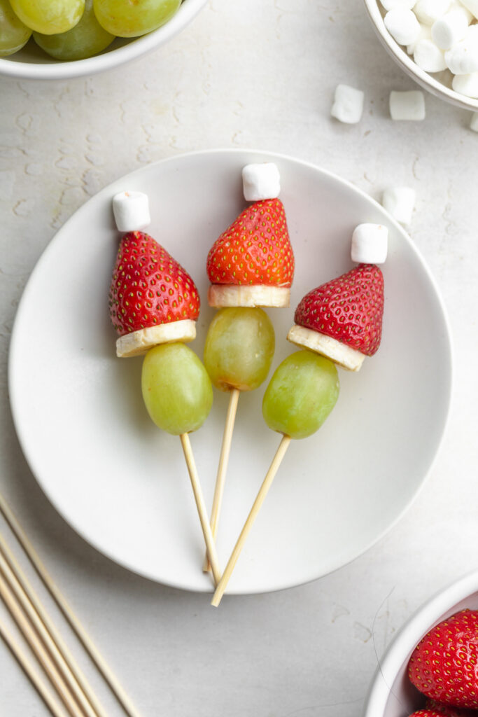 close-up image of grinch fruit kabobs on a plate