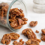 maple candied pecans tipped out of a jar