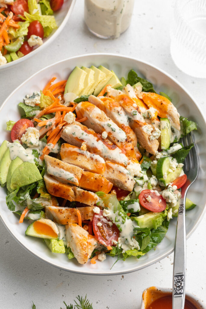 buffalo chicken salad in a bowl with a fork.