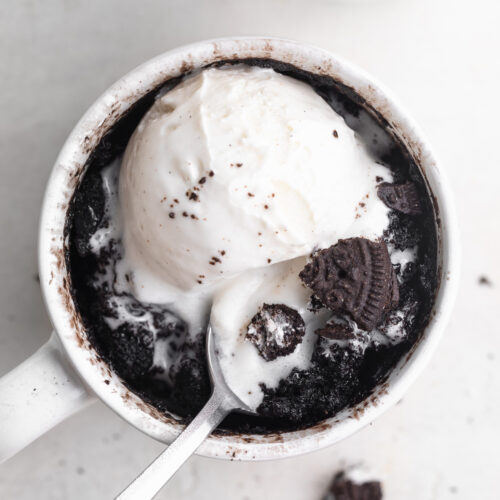 overhead image of oreo mug cake with a scoop of vanilla ice cream on top.
