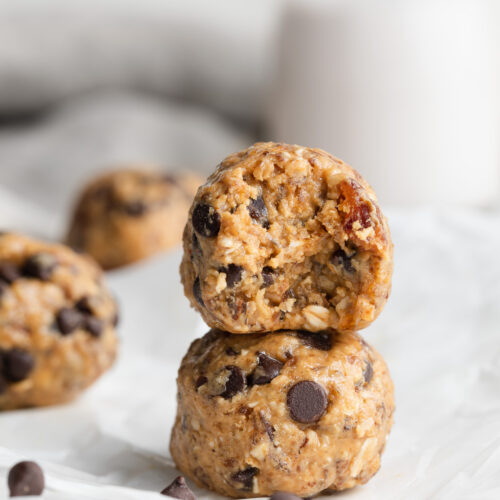 Two cookie dough dates bites stacked on top of each other.