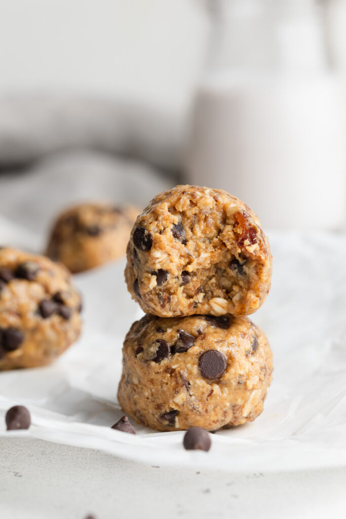 Two cookie dough dates bites stacked on top of each other.