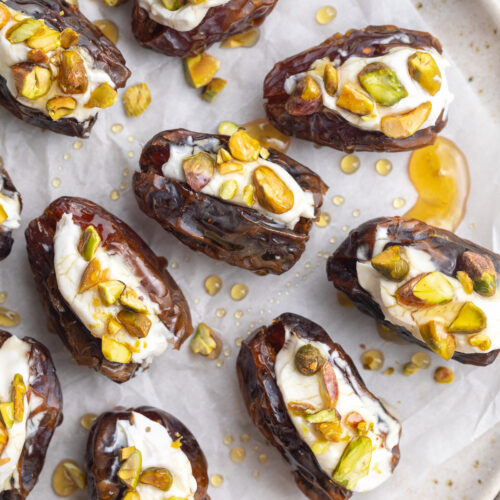 close-up overhead image of stuffed dates with cream cheese, pistachios, and honey.