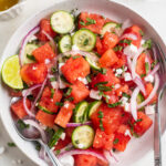overhead image of watermelon salad in a bowl.
