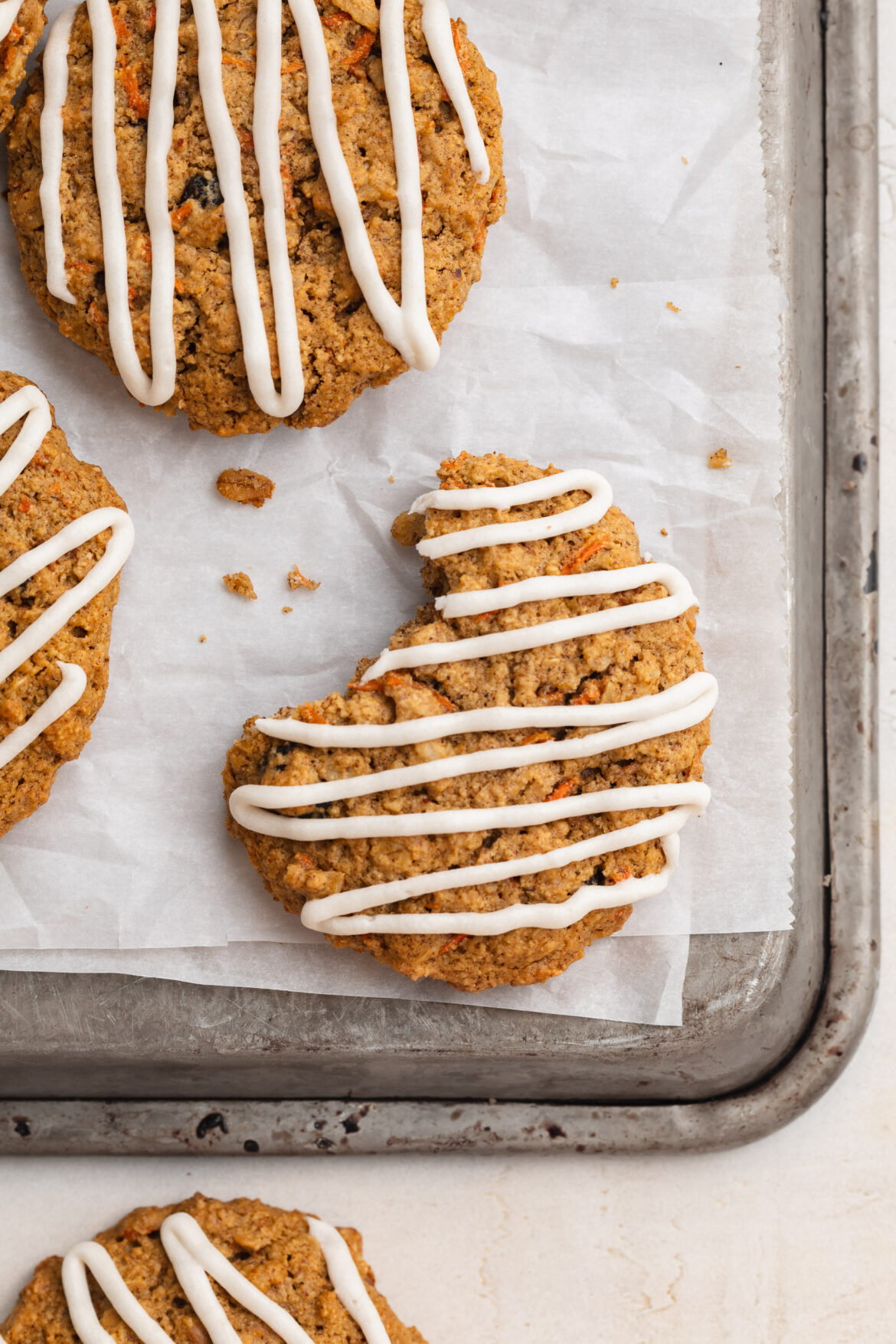 Healthy Carrot Cake Cookies (gluten-free!) Close-up overhead image of carrot cake cookies on a baking sheet.