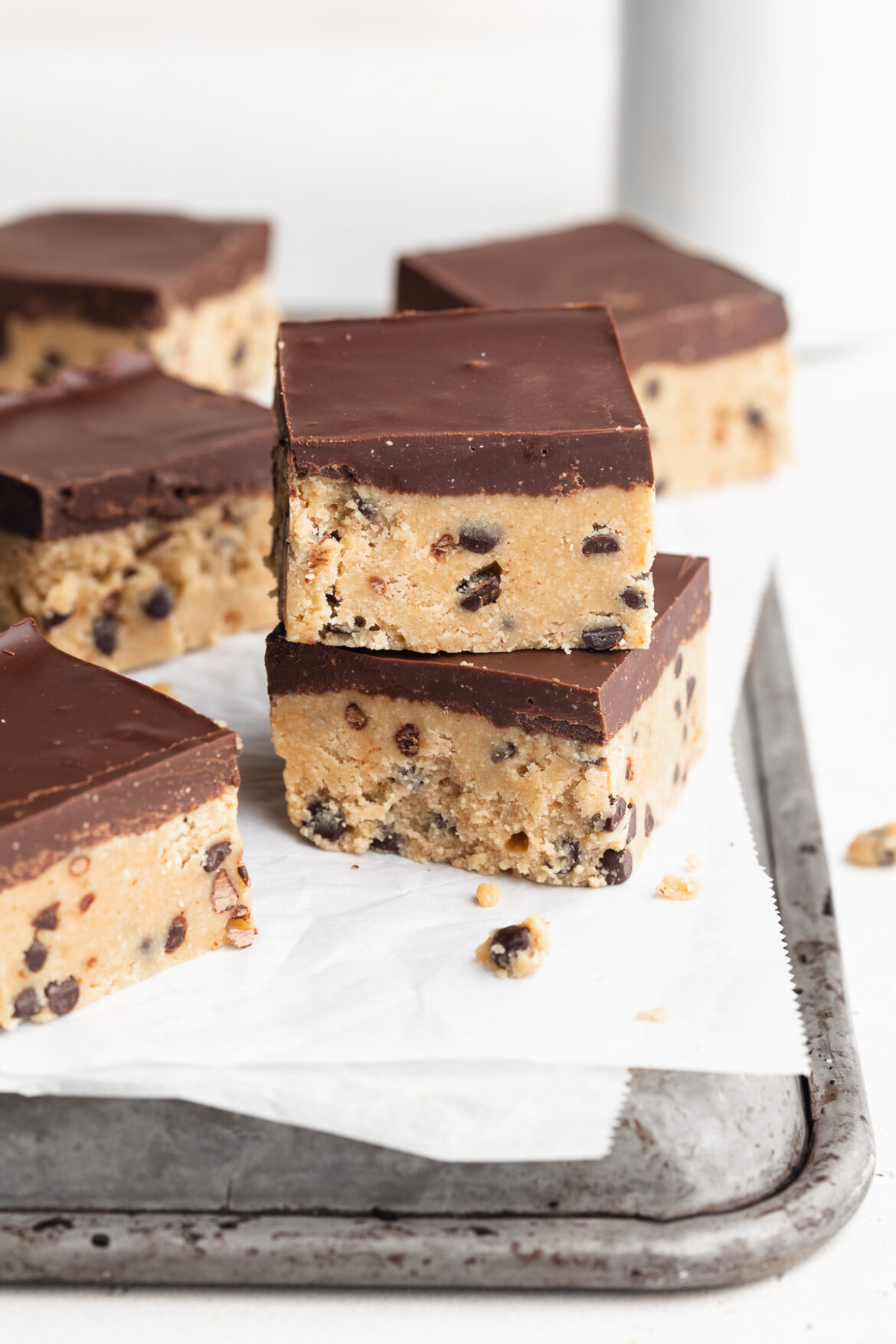 Healthy No-Bake Cookie Dough Bars two healthy no-bake cookie dough bars stacked on top of each other on a baking sheet.