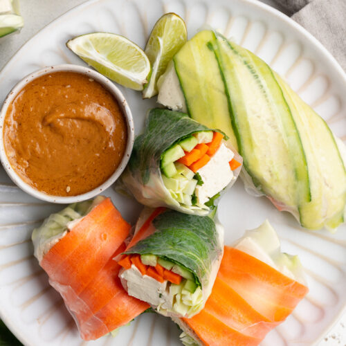 summer rolls with peanut dipping sauce on a plate.