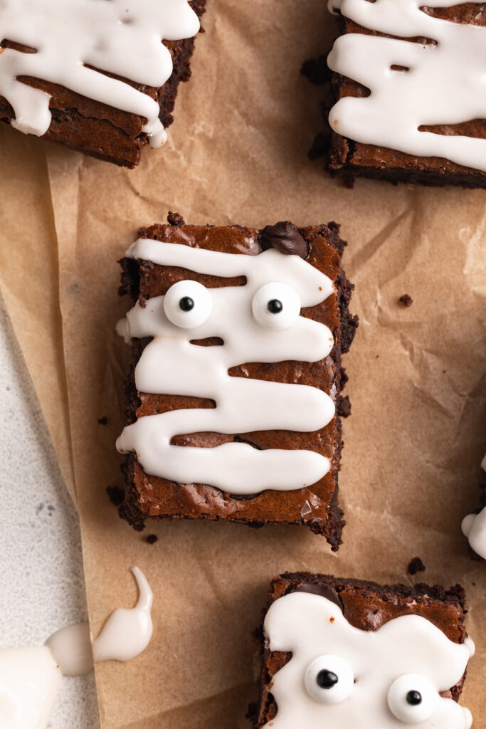 overhead close up image of mummy brownies with candy eyes.