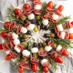 overhead image of antipasto wreath with fresh rosemary on a large plate.