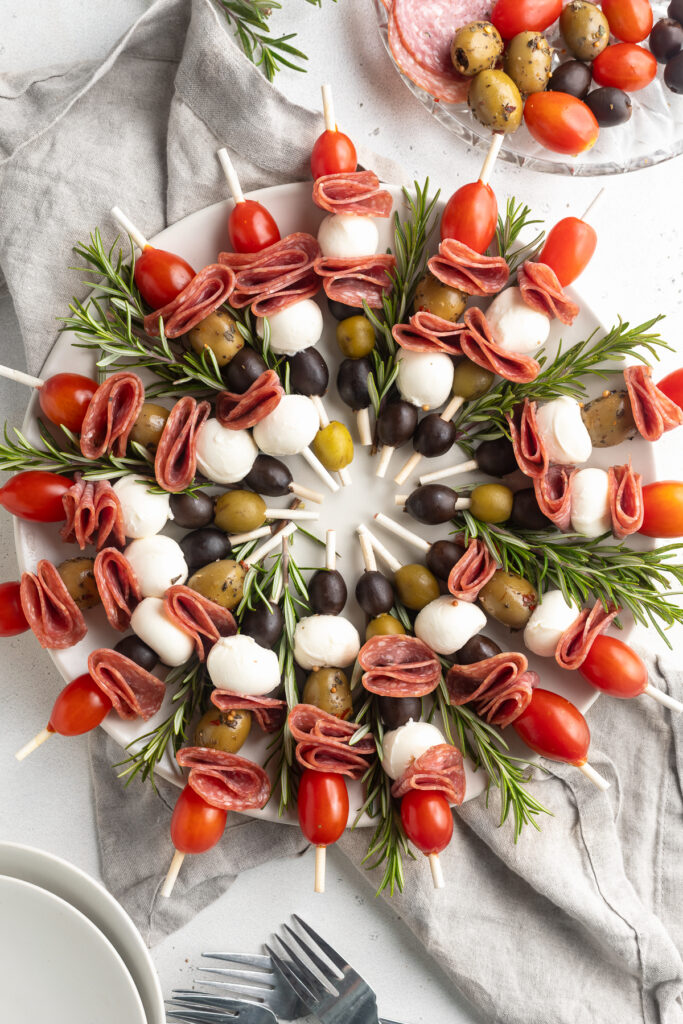 overhead image of antipasto wreath with fresh rosemary on a large plate.
