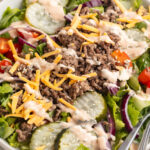 big mac salad in a bowl with sesame seeds on top.